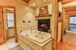 Bathroom has jetted tub, fireplace, and custom steam shower